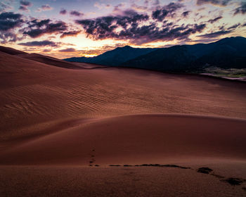 Scenic view of desert against sky during sunset in great sand dunes national park - colorado