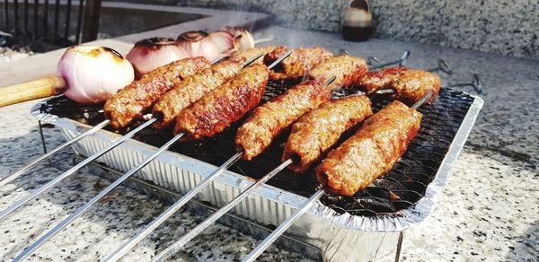 High angle view of meat on barbecue grill