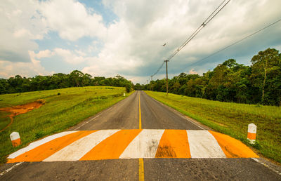 View of country road against cloudy sky