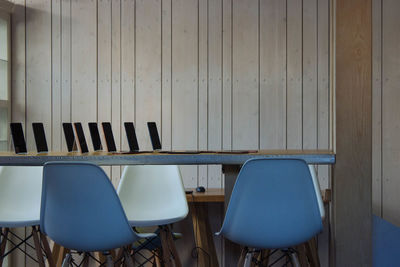 Technologies on table with empty chairs in conference room