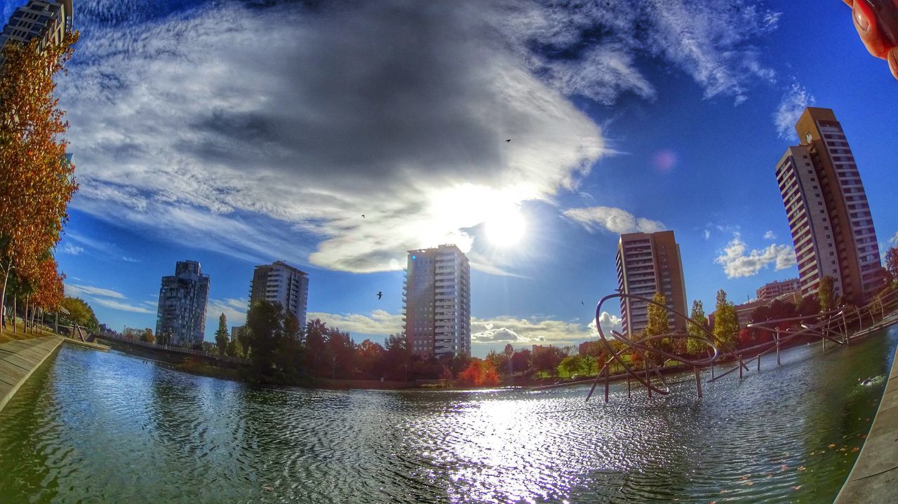 building exterior, architecture, built structure, water, city, skyscraper, sky, waterfront, reflection, modern, river, cityscape, cloud - sky, office building, tall - high, urban skyline, tower, cloud, building, blue