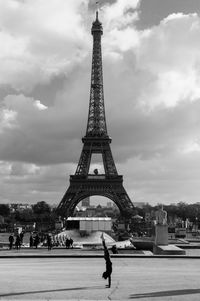 Eiffel tower against cloudy sky