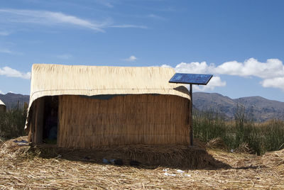 Built structure on field against sky