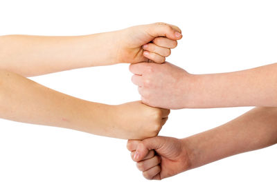 Cropped image of hand holding over white background