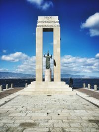 Low angle view of statue against sea and sky at arena dello stretto on sunny day