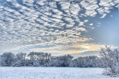 Snow covered landscape against sky