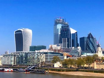 Modern buildings in city against clear sky