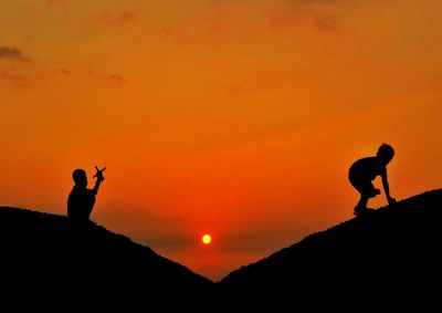 Silhouette of people at sunset