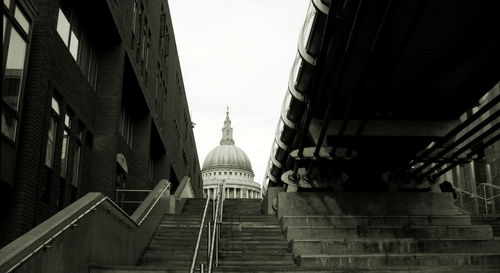 Low angle view of staircase in city against sky