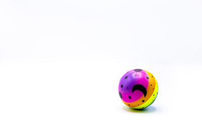 High angle view of multi colored ball on white background