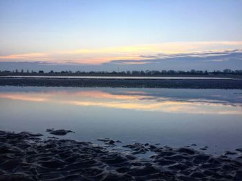 Scenic view of lake against sky during sunset