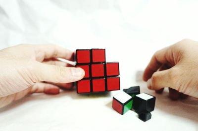 Close-up of hand holding over white background