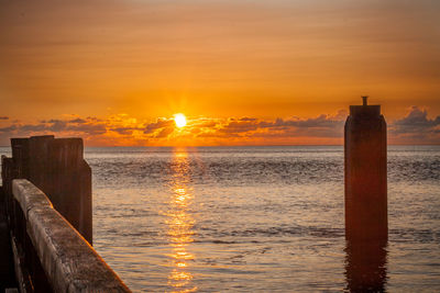 Scenic view of sea against orange sky