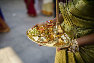 Low section of woman holding candles on temple