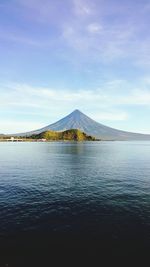 Distant view of mayon volcano against sky seen from sea