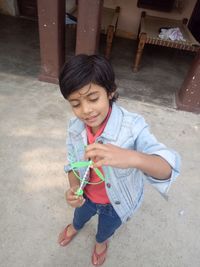 High angle view of cute boy holding umbrella