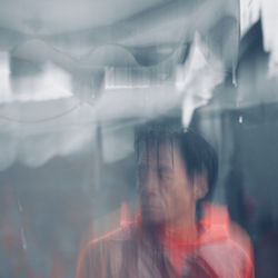 Portrait of man seen through glass window