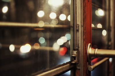 Close-up of illuminated train in city at night