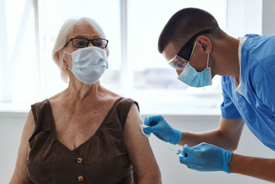 Doctor injecting vaccine to patient