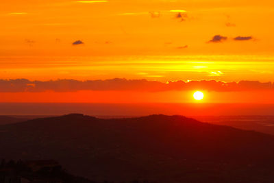 Scenic view of silhouette landscape against romantic sky at sunset