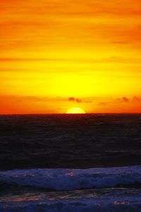 Scenic view of sea against orange sky