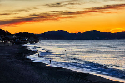 Scenic view of beach against sky during sunset