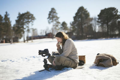 Photographer sitting on snow and relaxing