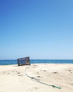 Scenic view of beach against clear blue sky