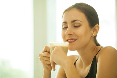 Woman having coffee at home