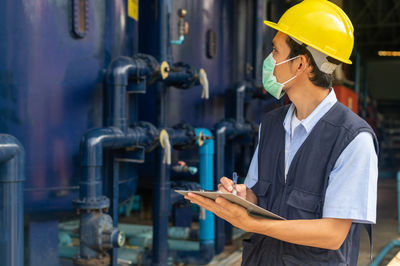 Portrait of young man working in factory