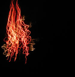 Low angle view of fireworks over black background