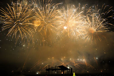 Low angle view of firework display at night