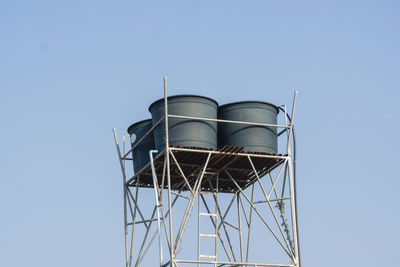 Low angle view of water tower against clear sky