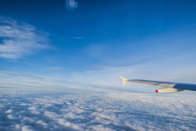 Scenic view of airplane wing against sky