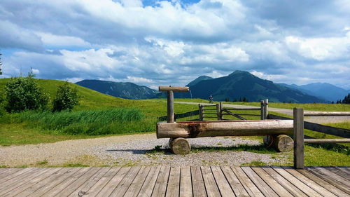 Bench in park against sky