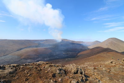 Smoke emitting from volcanic mountain against sky