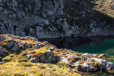 Rock formation on land by lake