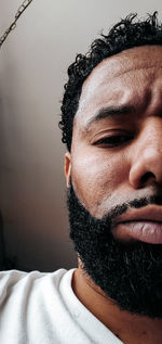 Close-up portrait of young man with eyes closed at home