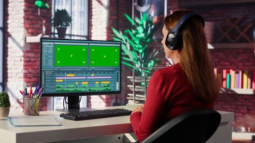 Portrait of young woman using mobile phone in office