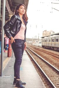 Woman standing on railroad station platform