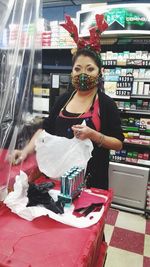 Portrait of smiling woman standing at store