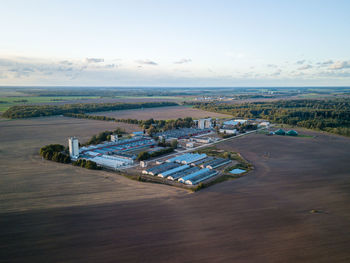 High angle view of road amidst field against sky