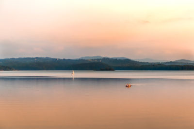Scenic view of lake against sky during sunset