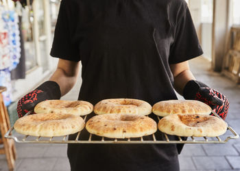 Chef keeps the pita on the wire rack after being baked in the electric oven