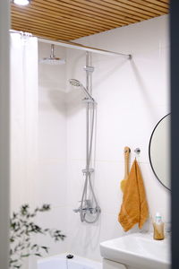 Modern bathroom interior in white tones with natural wood