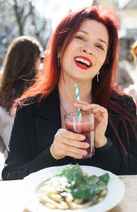 Portrait of young woman having food