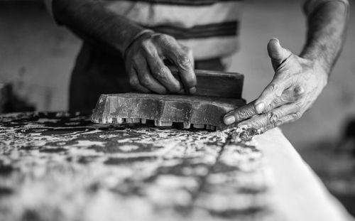 Close-up midsection of manual worker working at workshop