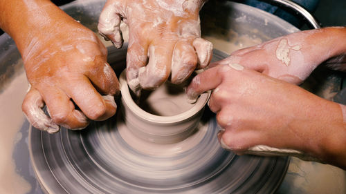 Cropped image of man making pottery at workshop