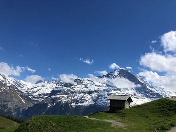 Scenic view of snowcapped mountains against blue sky