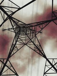 Low angle view of electricity pylon against sky